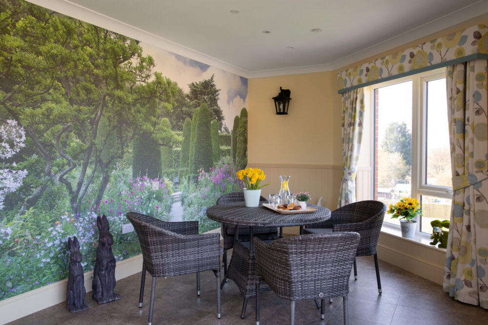 A garden-themed seating area at Cloverleaf with garden mural
